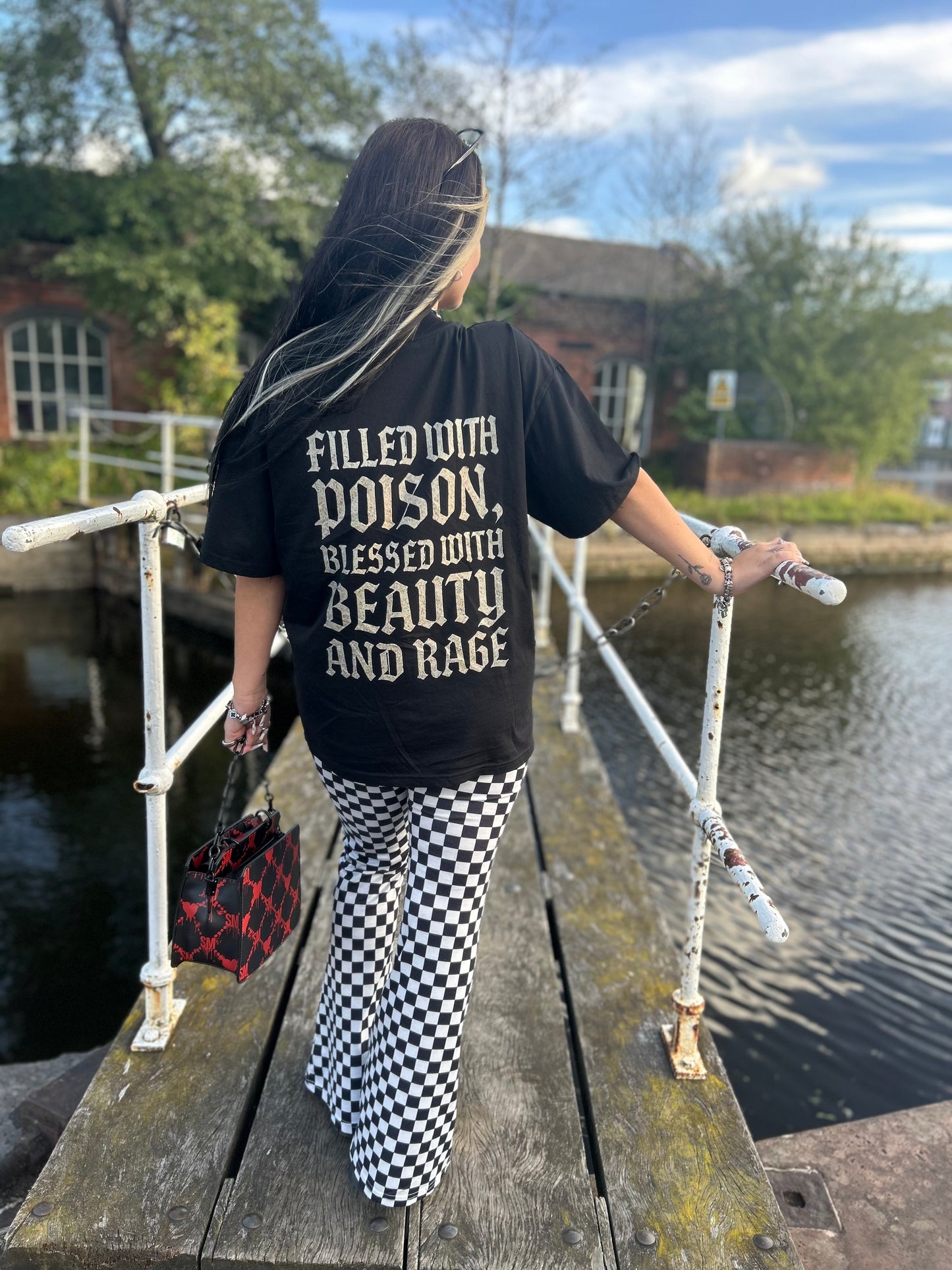 Full back view of ANG3L “Poison & Beauty” Oversized Gothic Tee with distressed gothic lettering on oversized fit.